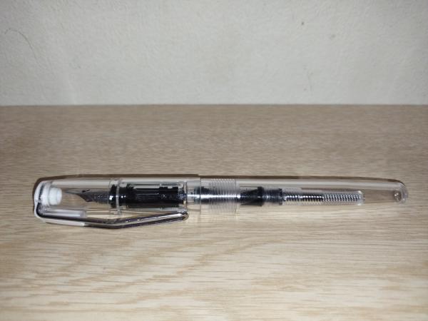 ターコイズブルーのインクを吸入したあとのコンバーター式万年筆。軸が透明なので、コンバーター内にインクが入っているのが見える